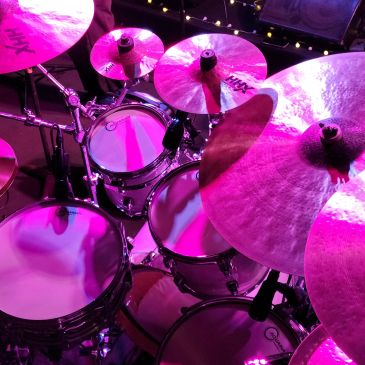 Drum kit illuminated by stage lighting