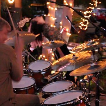 Drummer performing on stage with electronic kit