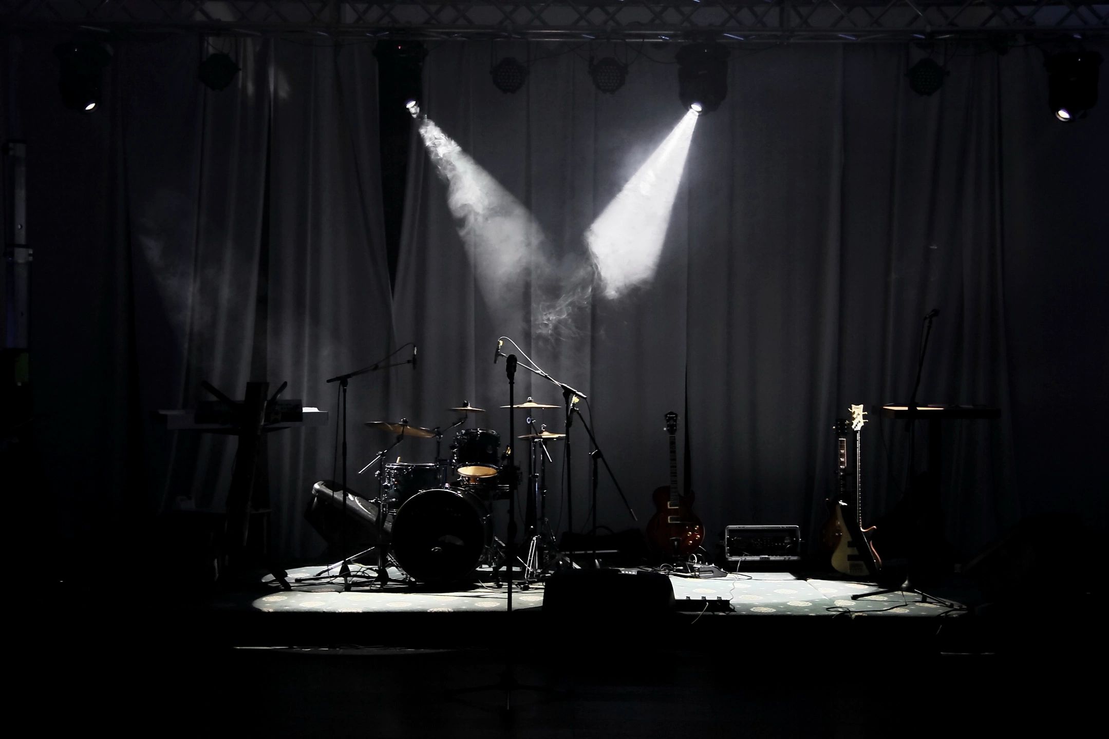 Concert stage with dramatic spotlight beams